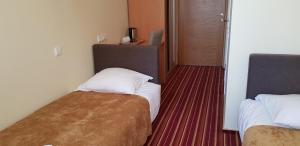Postel nebo postele na pokoji v ubytování Hotel Dainava