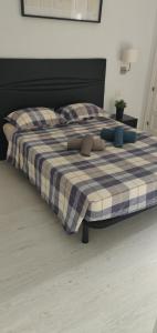 a large bed with a blue and white plaid blanket at Parque Santiago 2 - Playa de Las Américas Tenerife in Arona +29 photos