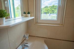 a bathroom with a sink and a window at Beach Apartments Marijana in Vodice