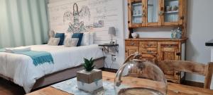 a bedroom with a bed and a table with a glass jar at Be Our Guest Self Catering in Nelspruit