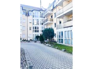 a cobblestone street in front of some buildings at SUNNYHOME Monteurwohnungen und Apartments in Weiden in Weiden +2 photos