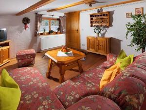 a living room with a couch and a table at Haus Michinglehen in Marktschellenberg