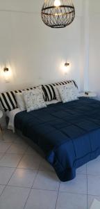a large bed with a blue comforter in a room at Santo Spiti sou 3 in Fira