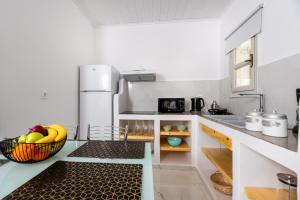 a kitchen with a bowl of fruit on the counter at GK Santorini home art in Perivolos