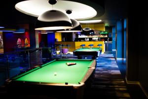 a billiard room with two pool tables and a bar at Hotel Mikołajki Leisure & SPA - Destigo Hotels in Mikołajki