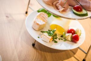 two plates of cheese and fruit on a table at WeinQuartier Bissersheim in Bissersheim