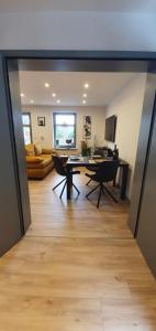 a dining room and living room with a table and chairs at Haus Malta Wohnung 2, 300m zum Strand in Graal-Müritz