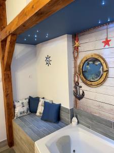 eine Badewanne in einem Zimmer mit blauen Kissen in der Unterkunft Dunakavics Boutique Apartman Szentendre in Szentendre