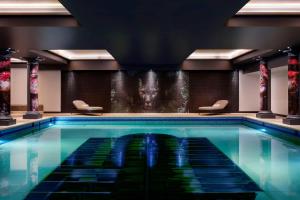 
a swimming pool with a pool table in it at NYX Hotel London Holborn by Leonardo Hotels in London

