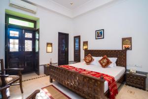 a bedroom with a large bed in a room at Ganga Heritage By Howard in Haridwār