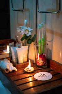 a table with toothbrushes and candles on a table at Ganga Heritage By Howard in Haridwār