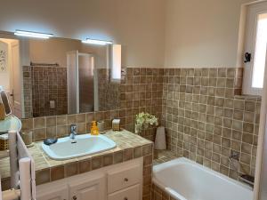 a bathroom with a sink and a bath tub at Au bord de la mer in Cavalaire-sur-Mer +17 photos