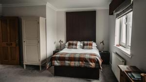 A bed or beds in a room at Broadford Hotel 