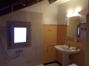 a bathroom with a sink and a shower with a window at Hotel Roc de St Miquel & Apartment in Soldeu