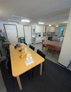 a room with a table and chairs and a kitchen at Hostel400Kokkola in Kokkola