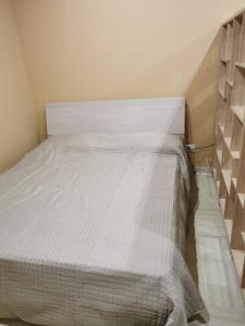 a bedroom with a bed with a white bedspread at Casa Mia1 in Foggia