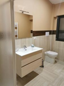 a bathroom with a sink and a toilet at Casa Mia1 in Foggia