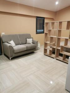 a living room with a couch and wooden shelves at Casa Mia1 in Foggia