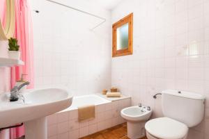 a bathroom with a sink and a toilet and a bath tub at Brisa Mar 1, 2 bedroom apartment, Cala'n Bosch in Son Xoriguer +46 photos
