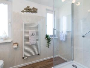 a bathroom with a shower and a toilet and a sink at Dünenrose in Tinnum +11 photos