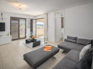 a living room with a couch and a tv at Apartment Residence Poreč in Poreč