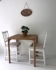 モノーポリにあるMagentaの鉢植えのテーブルと椅子2脚