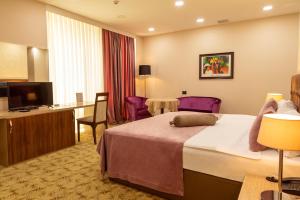 Postel nebo postele na pokoji v ubytování West Shine Hotel