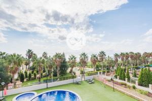 a view from the balcony of a resort with two pools at Vila Dorpesa X-CM in Oropesa del Mar