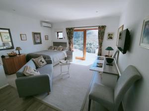 a bedroom with a bed and a living room at Admiral's Waterfall Self-Catering in Simonʼs Town