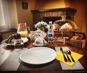 a table with a white plate and some food on it at La valle B&B in Cavriglia