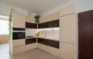 a kitchen with white cabinets and a sink at Apartment Marcela in Sutivan