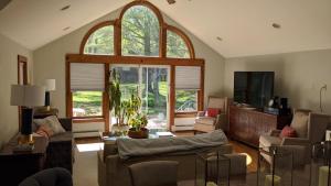 a living room with a couch and a large window at Private Berkshire Escape Special April Pricing select your dates for discount Monthly Pricing in Lee