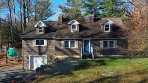 a brown house with a blue door on a yard at Private Berkshire Escape Special April Pricing select your dates for discount Monthly Pricing in Lee