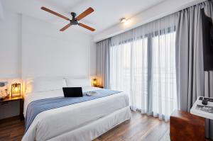 a bedroom with a bed with a laptop on it at Gran Hotel Flamingo-Adults Only older 18 years old in Lloret de Mar
