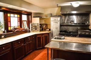 a large kitchen with a stove and a sink at Brook Road Inn in Goshen