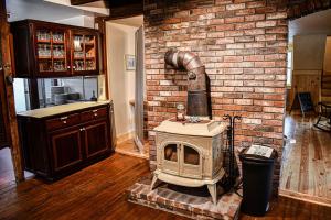 a brick wall with a wood stove in a room at Brook Road Inn in Goshen