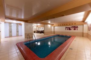 a pool in a large room with a large room with at Hotel Yaik in Orenburg