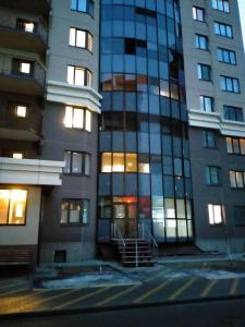 a tall building with lights on in front of it at Sunflower Aparts 36 in Voronezh