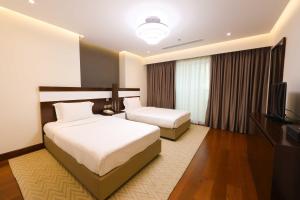 Katil atau katil-katil dalam bilik di Number One Tower Suites