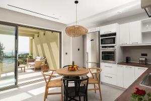 a kitchen and dining room with a table and chairs at paleo villas in Lákones