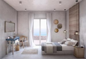a bedroom with a bed and a large window at Mirabelle Luxury Villas in Plaka