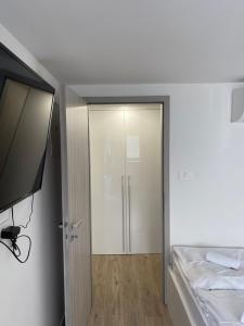 a bedroom with a sliding door and a bed at Blue Casa in Koper