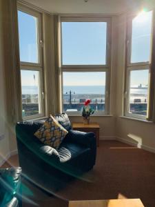 salon z kanapą przed oknami w obiekcie Cunard Apartments w mieście Douglas