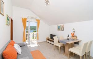 a living room with a table and a dining room at Bijela Villa in Slano