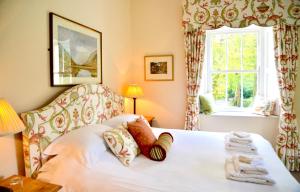 a bedroom with a bed with towels on it at Delphi Lodge in Leenaun
