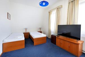 Una cama o camas en una habitación de Hotel Laguna Slapy