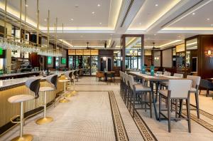 a restaurant with tables and chairs and a bar at Barceló Istanbul in Istanbul