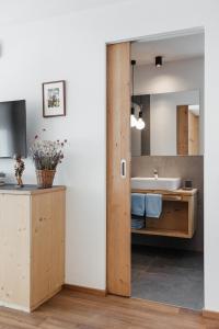 een badkamer met een wastafel en een spiegel bij Appartamenti Ciasa Hanny in Colfosco
