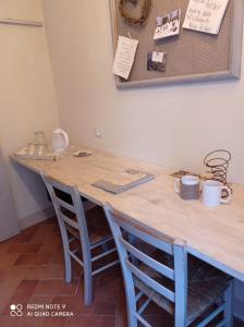 uma mesa com duas cadeiras e um balcão de madeira em Agula Relais camera matrimoniale em Pugnano