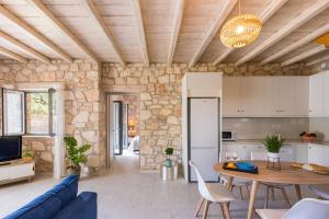 a kitchen and living room with a blue couch and a table at Ionio villa Zafeiris in Vasilikos